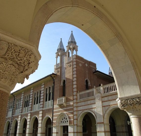 College steeple seen through arch of building.