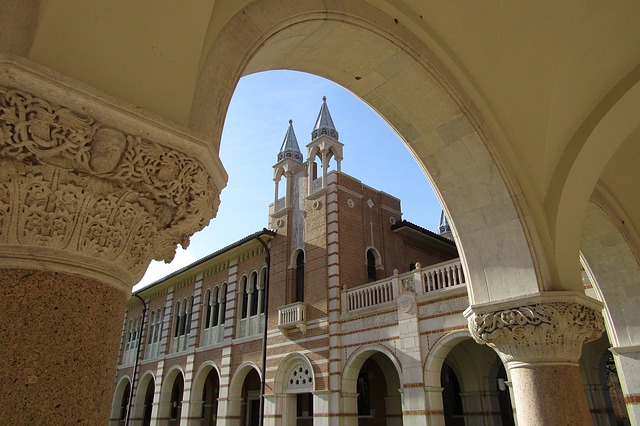College steeple seen through arch of building.