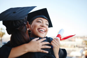 a college student hugging a friend on graduate day