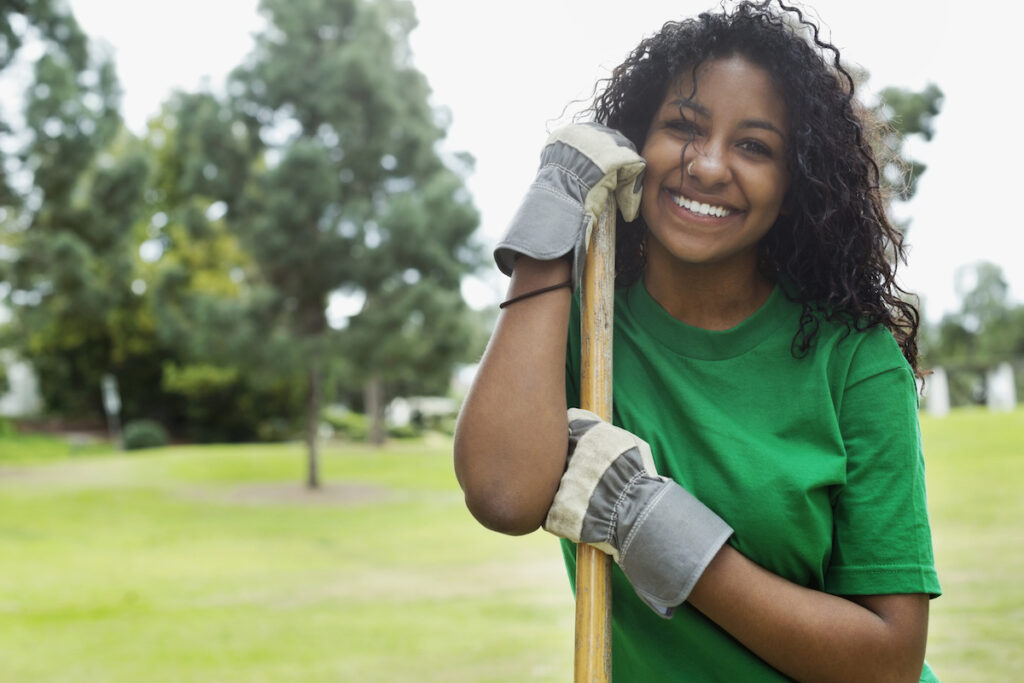 Young woman volunteering in park.