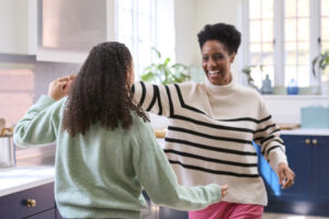 parent and child dancing in kitchen