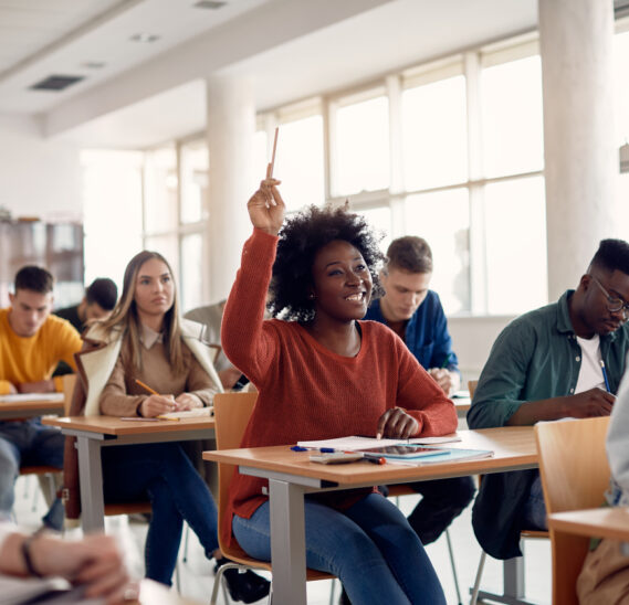 classroom with African American student raising their hand