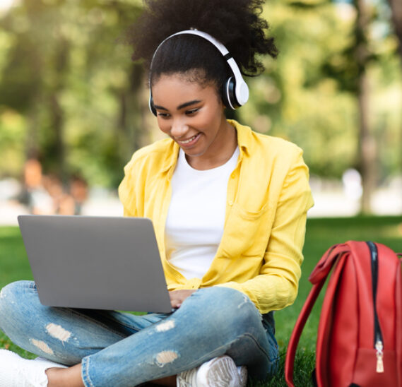 Joyful African Student Girl On Laptop Watching Video : How to Pick a College Major